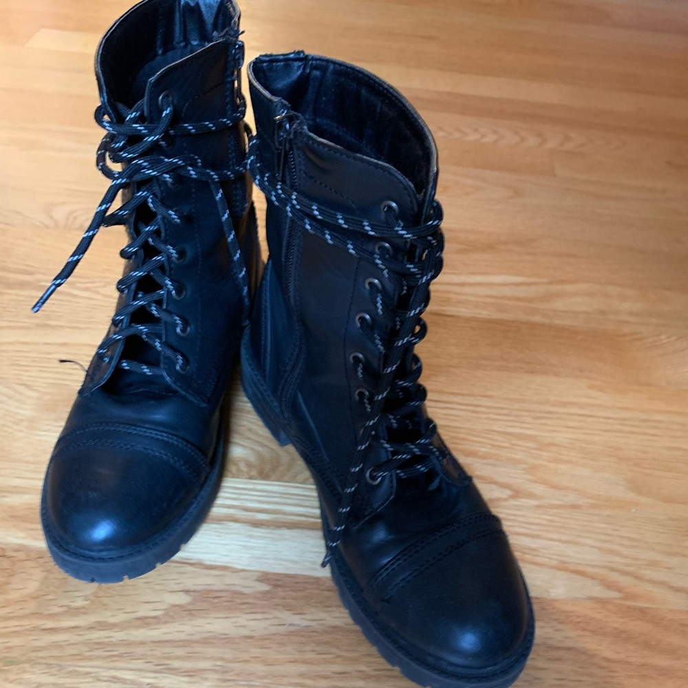 Boots with lace up front, inside zipper, and traction on soles.
